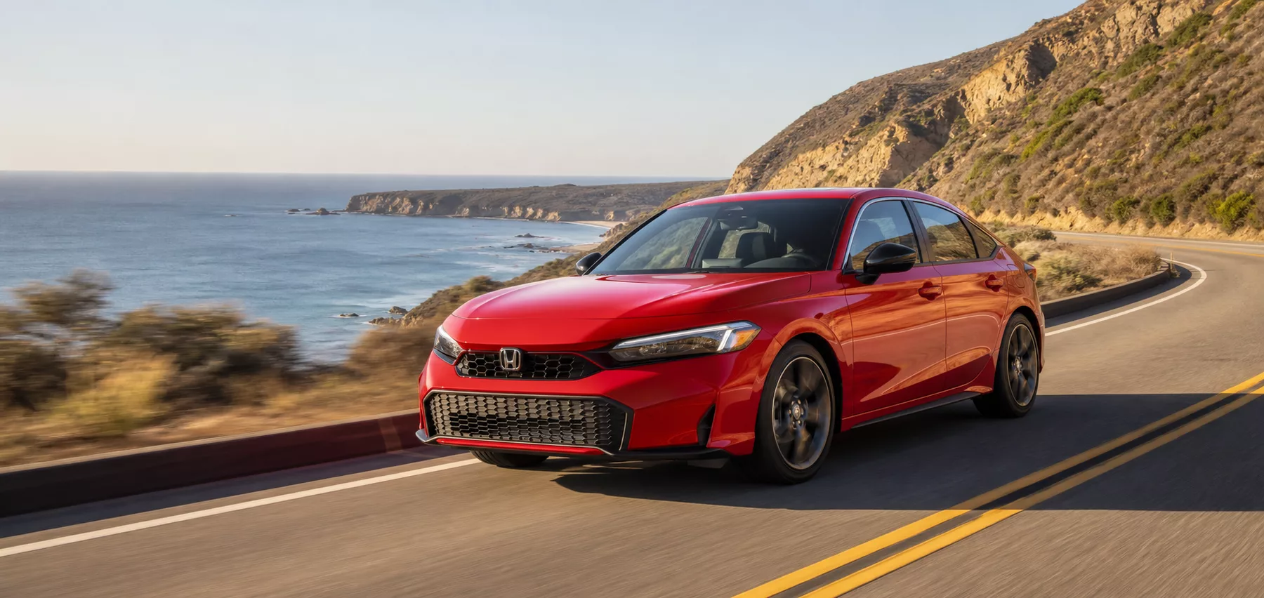 Honda Civic driving on a coastal road